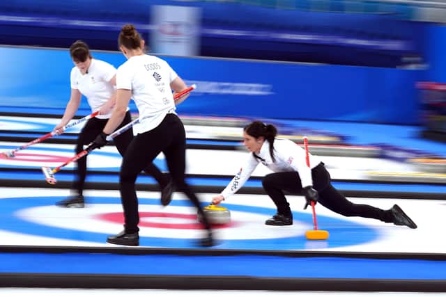 Great Britain's Eve Muirhead (right) plays the stone as Hailey Duff (left) and Jennifer Dodds sweeps the ice in the Women's Gold Medal Game at the National Aquatics Centre in Beijing. Picture: Andrew Milligan/PA