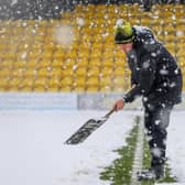 Harrogate Town staff and volunteers attempted to clear the EnviroVent Stadium pitch of snow ahead of Saturday's scheduled League Two fixture with Leyton Orient.  Pictures: Matt Kirkham