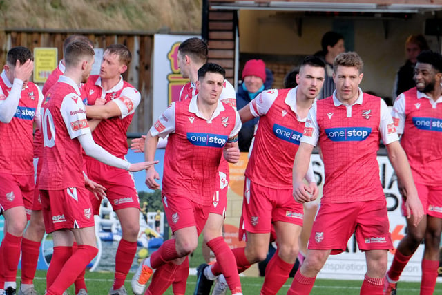 Scarborough Athletic players congratulate skipper Michael Coulson, centre, after he hit the leveller at home to FC United of Manchester

Photo by Richard Ponter