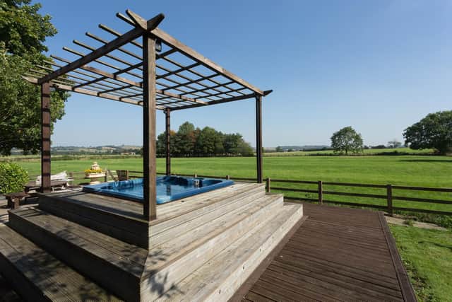 The property has a landscaped garden plus decking with entertaining area and a hot tub overlooking the rural view