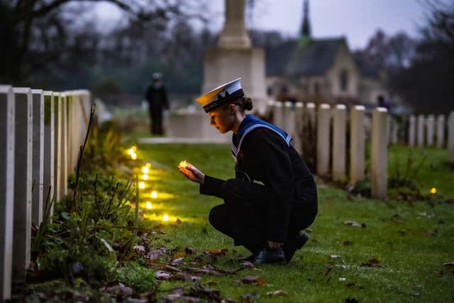 Sea Cadet Lucia Leeming-Sheppard places candles at Canadian Air Force graves during a Candlelit Christmas Remembrance at the Commonwealth War Graves at Stonefall Cemetery, Harrogate, in December. Picture: Tony Johnson.