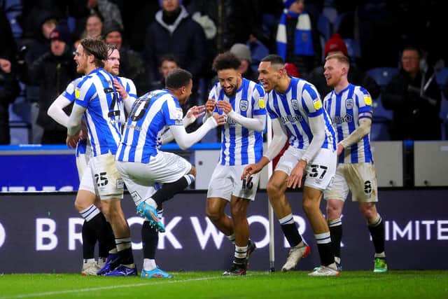Huddersfield Town's Jon Russell celebrates with his team-mates after scoring their side's second goal of the game (Picture: Simon Marples/PA)