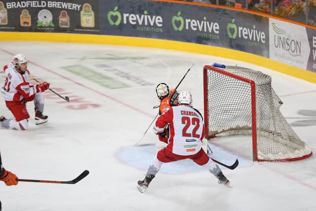 Brodie Reid, far left, fires home past Rok Stojanovic in the 15th minute to put Cardiff Devils 1-0 ahead. Picture: Hayley Roberts/EIHL.