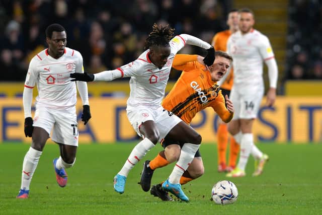 MAKING A DIFFERENCE: Barnsley's Domingos Quina, left, takes on 
Hull City's Regan Slater. Picture: Bruce Rollinson