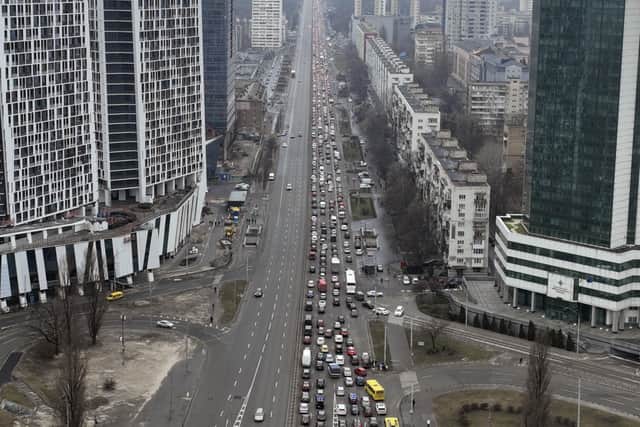 Traffic jams are seen as people leave the city of Kyiv, Ukraine, Thursday, Feb. 24, 2022. Russian President Vladimir Putin on Thursday announced a military operation in Ukraine and warned other countries that any attempt to interfere with the Russian action would lead to "consequences you have never seen." (AP Photo/Emilio Morenatti).