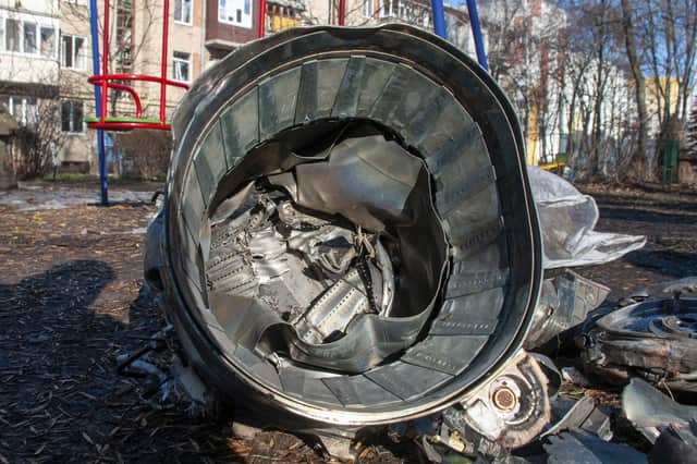 Fragments of military equipment lies on the street the aftermath of an apparent Russian strike in Kharkiv in Kharkiv, Ukraine, Thursday, Feb. 24, 2022. Russian troops have launched their anticipated attack on Ukraine. Big explosions were heard before dawn in Kyiv. (AP Photo/Andrew Marienko)