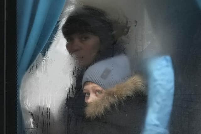 A woman and child peer out of the window of a bus as they leave Sievierodonetsk, the Luhansk region, eastern Ukraine.