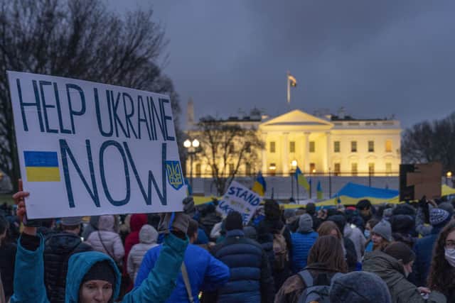 People take part in a vigil to protest the Russian invasion of Ukraine in front of the White House in Washington.