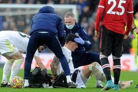 INJURY: Robin Koch is treated against Manchester United
