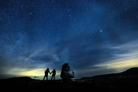Walkers look up into the night sky above Twistleton Scar in The Yorkshire Dales National Park. The Yorkshire Dales National Park was officially designated a Dark Sky Reserve by the International Dark Sky Association in December 2020. (Photo: Danny Lawson/PA Wire)