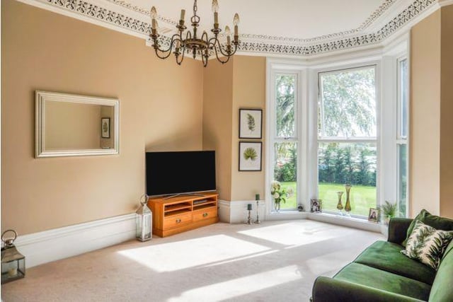 There are plenty of reception rooms in the property. This one benefits from stunning period bay windows overlooking the land.