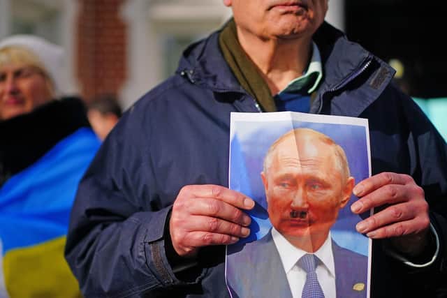 A protester outside the Russian Embassy in London  where a vigial has been held following this week's invasion of Ukraine.