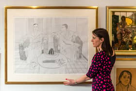 Francesca Young, Picture Specialist at Tennants Auctioneers infront of Lot 2081 David Hockney OM, CH, RA (b.1937) "Christopher Isherwood and Don Bachardyâ€ Signed and dated (19)76, numbered 67/96, lithograph, 71cm by 94cm. Writer: James Hardisty