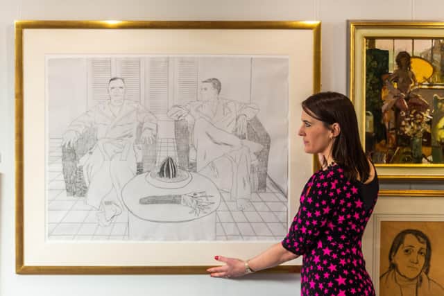 Francesca Young, Picture Specialist at Tennants Auctioneers infront of Lot 2081 David Hockney OM, CH, RA (b.1937) "Christopher Isherwood and Don Bachardyâ€ Signed and dated (19)76, numbered 67/96, lithograph, 71cm by 94cm. Writer: James Hardisty