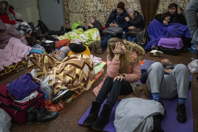 People rest in the Kyiv subway, using it as a bomb shelter in Kyiv, Ukraine, Thursday, Feb. 24, 2022. (AP Photo/Emilio Morenatti)