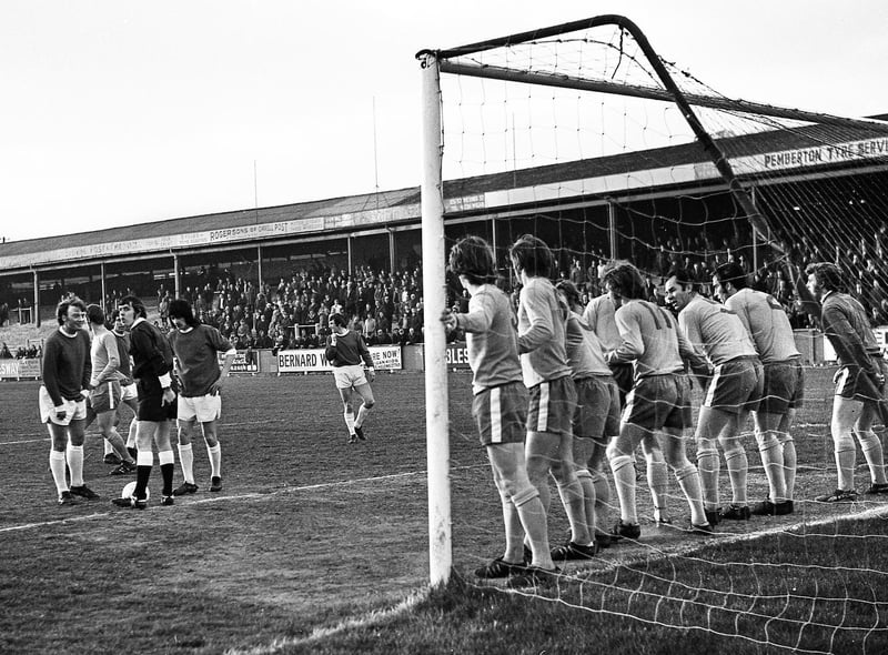 Wigan Athletic full back, Billy Sutherland, is all smiles as he sees the Gainsborough Trinity players on the goal line waiting for him to take a free kick inside the penalty area during the Northern Premier League cup final at Springfield Park on Monday 24th of April 1972.
Latics lost 0-2 but had secured the trophy for the first time after winning the first leg 4-0 away.