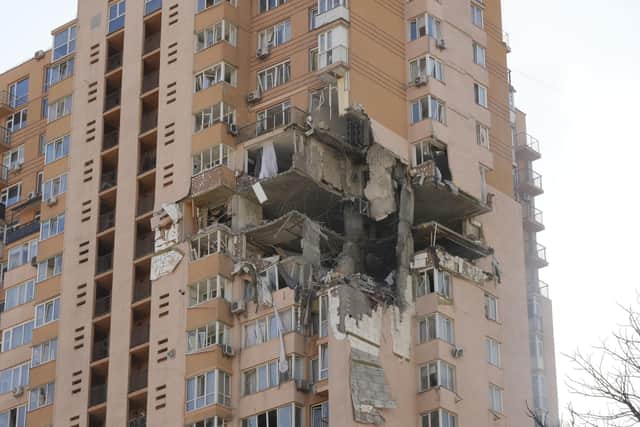 An apartment building damaged following a rocket attack on the city of Kyiv, Ukraine, Saturday, Feb. 26, 2022. Russian troops stormed toward Ukraine's capital Saturday, and street fighting broke out as city officials urged residents to take shelter. (AP Photo/Efrem Lukatsky).