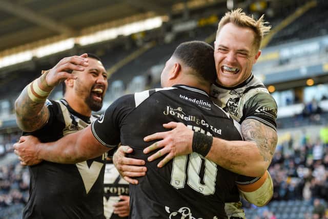VICTORY: Chris Satae of Hull FC is surrounded by teammates including Adam Swift (R) and Ligi Sao (L) after scoring a try against Salford Red Devils. Picture: Will Palmer/SWpix.com