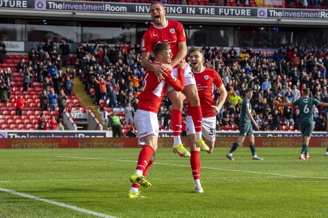 Happy Reds: 
Tykes' Mads Andersen celebrates his goal with Carlton Morris and Michal Helik.  Picture Tony Johnson