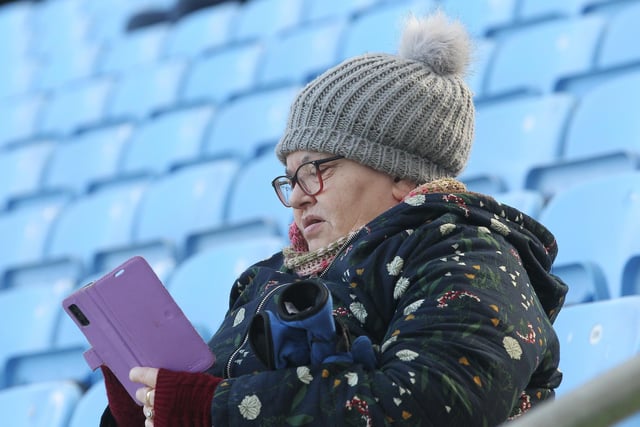 A PNE fan looks at her mobile before the Coventry game