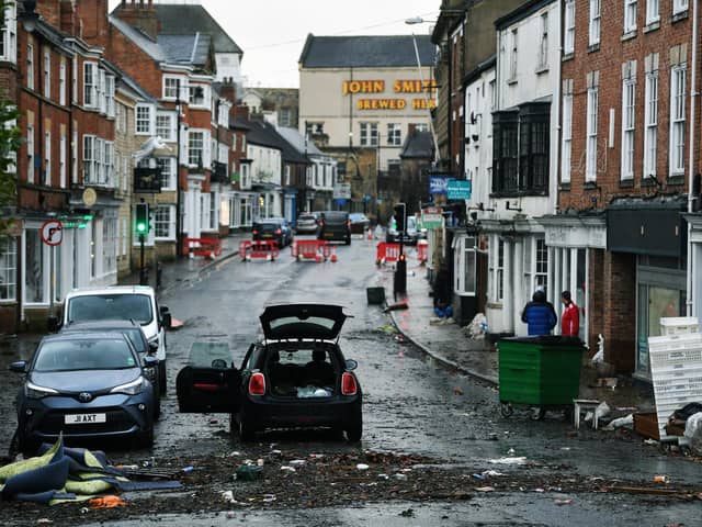 Businesses clean up on Bridge Street in Tadcaster after the River Wharfe flooded the town. 22nd February 2022. Picture : Jonathan Gawthorpe