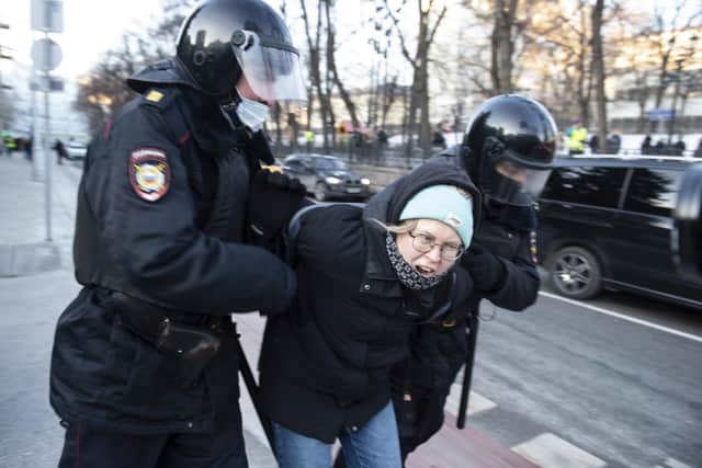 Police detain a demonstrator during an action against Russia's attack on Ukraine in Moscow, Russia, Sunday, Feb. 27, 2022. Protests against the Russian invasion of Ukraine resumed on Sunday, with people taking to the streets of Moscow and St. Petersburg and other Russian towns for the third straight day despite mass arrests. (AP Photo/Denis Kaminev).