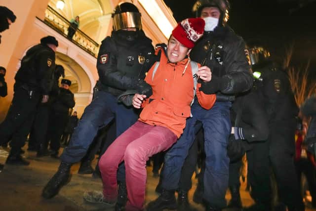 Police detain a demonstrator during an action against Russia's attack on Ukraine in St. Petersburg, Russia, Sunday, Feb. 27, 2022. Protests against the Russian invasion of Ukraine resumed on Sunday, with people taking to the streets of Moscow and St. Petersburg and other Russian towns for the third straight day despite mass arrests. (AP Photo/Dmitri Lovetsky).