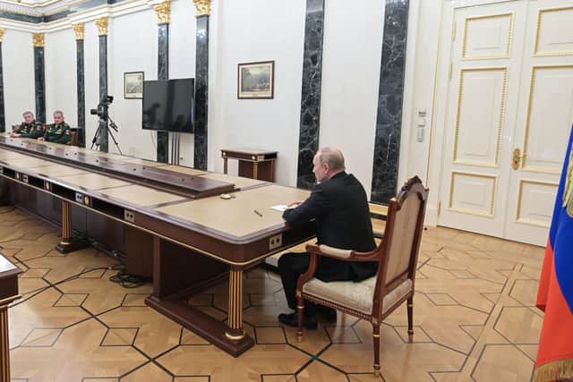 Russian President Vladimir Putin, right, speaks to Russian Defense Minister Sergei Shoigu, second left, and Head of the General Staff of the Armed Forces of Russia and First Deputy Defense Minister Valery Gerasimov, left, during their meeting in Moscow, Russia, Sunday, Feb. 27, 2022. Putin has ordered Russian nuclear forces on high alert amid tensions with the West over his invasion of Ukraine. (Alexei Nikolsky, Sputnik, Kremlin Pool Photo via AP).