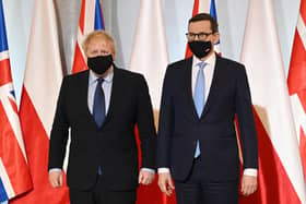 Prime Minister Boris Johnson (left) is greeted by Polish Prime Minister Mateusz Morawiecki at the Chancellery in Warsaw, Poland