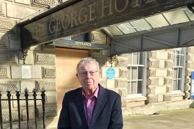 Coun Peter McBride outside the iconic George Hotel in Huddersfield town centre. (Image: Kirklees Council)