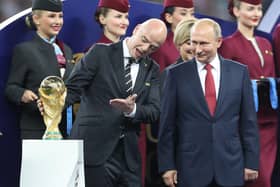FIFA President Gianni Infantino (left) and Russian President Vladimir Putin with the World Cup trophy.