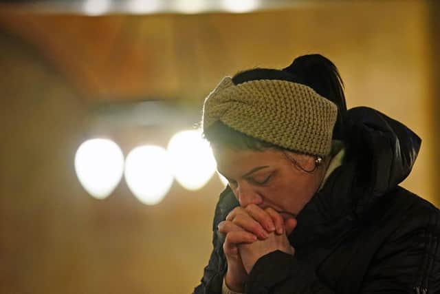 A person praying at the Ukrainian Catholic Cathedral of the Holy Family in London, following Russia's invasion of Ukraine