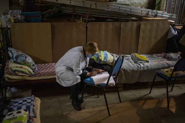 A nurse takes notes in diary at a basement used as a bomb shelter at the Okhmadet children's hospital in central Kyiv, Ukraine, Tuesday, March 1. 2022. Russian strikes pounded the central square in Ukraine???s second-largest city and other civilian targets, and a 40-mile convoy of tanks and other vehicles threatened the capital. (AP Photo/Emilio Morenatti).