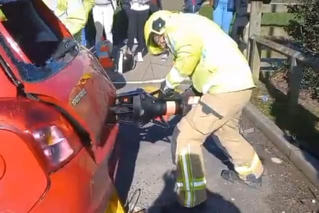 The video shows a firefighter using the spreader