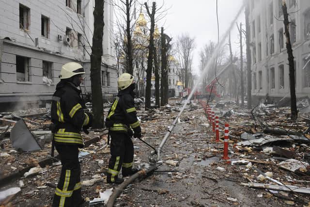 Firefighters extinguish a building of Ukrainian Security Service (SBU) after a rocket attack in Kharkiv, Ukraine's second-largest city, Ukraine, Wednesday, March 2, 2022. (AP Photo/Andrew Marienko)