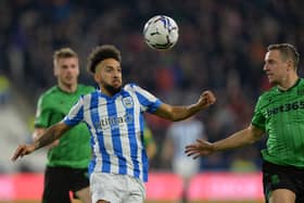 AMBITIOUS: Huddersfield Town's Sorba Thomas battles for possession with Stoke City's Phil Jagielka.
 Picture: Bruce Rollinson