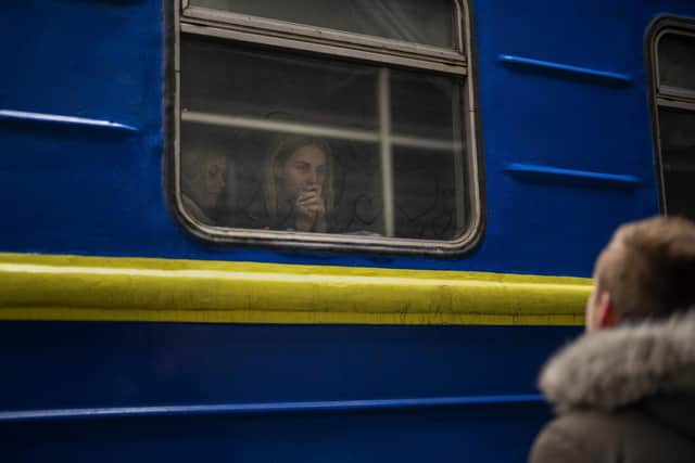 ogdan, 41, says goodbye to his wife Lena, 35, on a train to Lviv at the Kyiv station, Ukraine, Thursday, March 3. 2022. Bogdan is staying to fight while his family is leaving the country to seek refuge in a neighbouring country. (AP Photo/Emilio Morenatti).