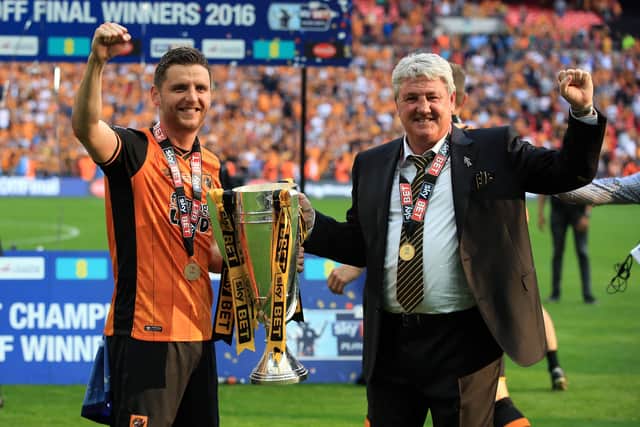 Hull City's Alex Bruce and manager Steve Bruce with the trophy after winning the Championship Play-off Final at Wembley. Picture: PA.