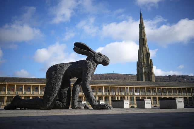 Crawling Lady-Hare by British sculptor Sophie Ryder is displayed in the courtyard of the historic Piece Hall on February 10, 2022 in Halifax, England. Photo by Christopher Furlong/Getty Images.
