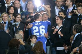 There are calls for tougher sanctions against oligarchs like Chelsea FC owner Roman Abramovich who is selling the Premie League club and who is pictured with former player John Terry.