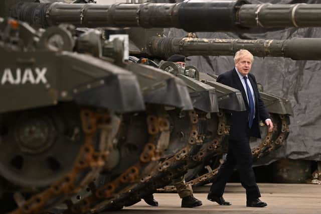 Prime Minister Boris Johnson is shown around the Royal Tank Regiment Battlegroup by Lt Colonel Simon Worth (left) after a press conference at the Tapa Army Base in Tallinn, Estonia, but should the Government be reversing Army cuts?