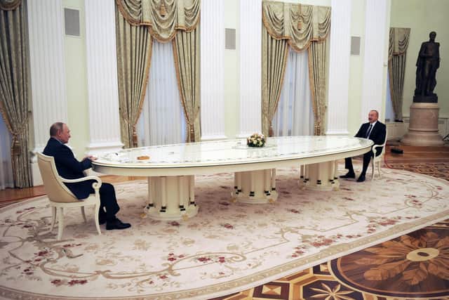 One theory for the huge tables we have repeatedly seen President Putin using is that he may be receiving treatment for an illness that is suppressing his immune system, making him more vulnerable to infections. Here he meets with his Azerbaijani counterpart Ilham Aliyev at the Kremlin in Moscow on February 22, 2022. (Photo by MIKHAIL KLIMENTYEV/SPUTNIK/AFP via Getty Images)