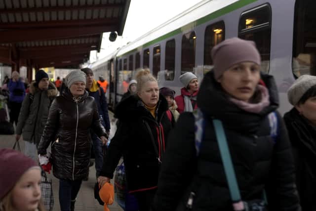 Refugees fleeing the war in Ukraine arrive at the train station in Przemysl, Poland, Sunday, March 6, 2022. (AP Photo/Markus Schreiber),