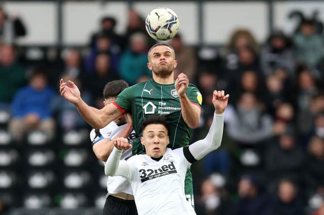 Barnsley's Carlton Morris and Derby County's Lee Buchanan battle for the ball. Picture: PA.