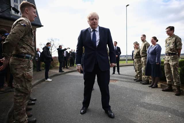Prime Minister Boris Johnson reviews troops during a visit to at RAF Northolt in London.