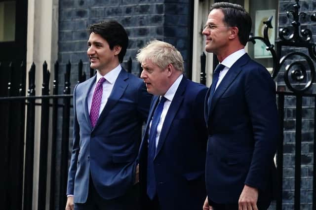 Prime Minister Boris Johnson (centre) leaves 10 Downing Street, London, with the Canadian Prime Minister Justin Trudeau (left) and the Dutch Prime Minister Mark Rutte (right)