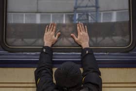 Aleksander, 41, presses his palms against the window as he says goodbye to his daughter Anna, 5, on a train to Lviv at the Kyiv station, Ukraine, Friday, March 4. 2022. Aleksander has to stay behind to fight in the war while his family leaves the country to seek refuge in a neighbouring country. (AP Photo/Emilio Morenatti).