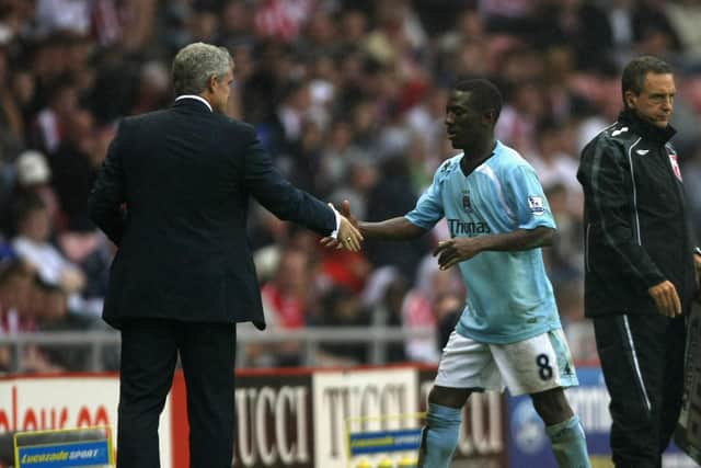 FORMER ACQUANTANCES: Mark Hughes, left, with Shaun Wright-Phillips, right, at Manchester City. Picture: Getty Images.