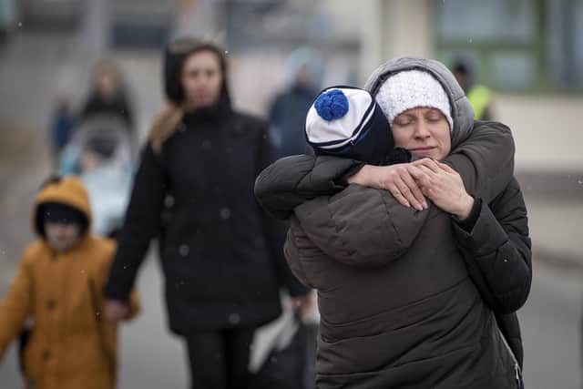 Refugees fleeing Ukraine reunite at the border crossing in Medyka, Poland, Monday, March 7, 2022. (AP Photo/Visar Kryeziu)