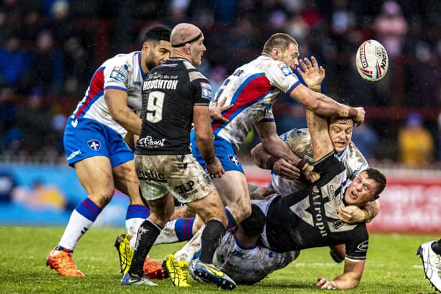 LEARNING FAST: Hull FC's Jack Brown manages to offload under pressure during the recent Super Leagu win over Wakefield Trinity  Picture: Tony Johnson.